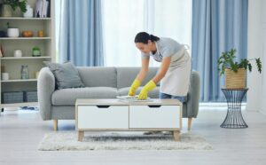 Cleaning is for weekends. Shot of a young woman cleaning at home.